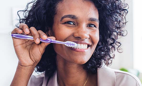 Woman brushing teeth